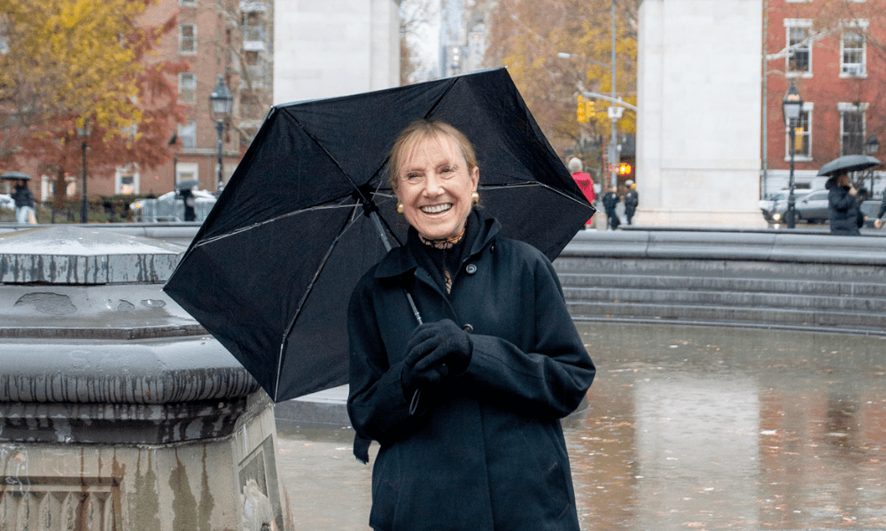 Woman smiling next to a fountain
