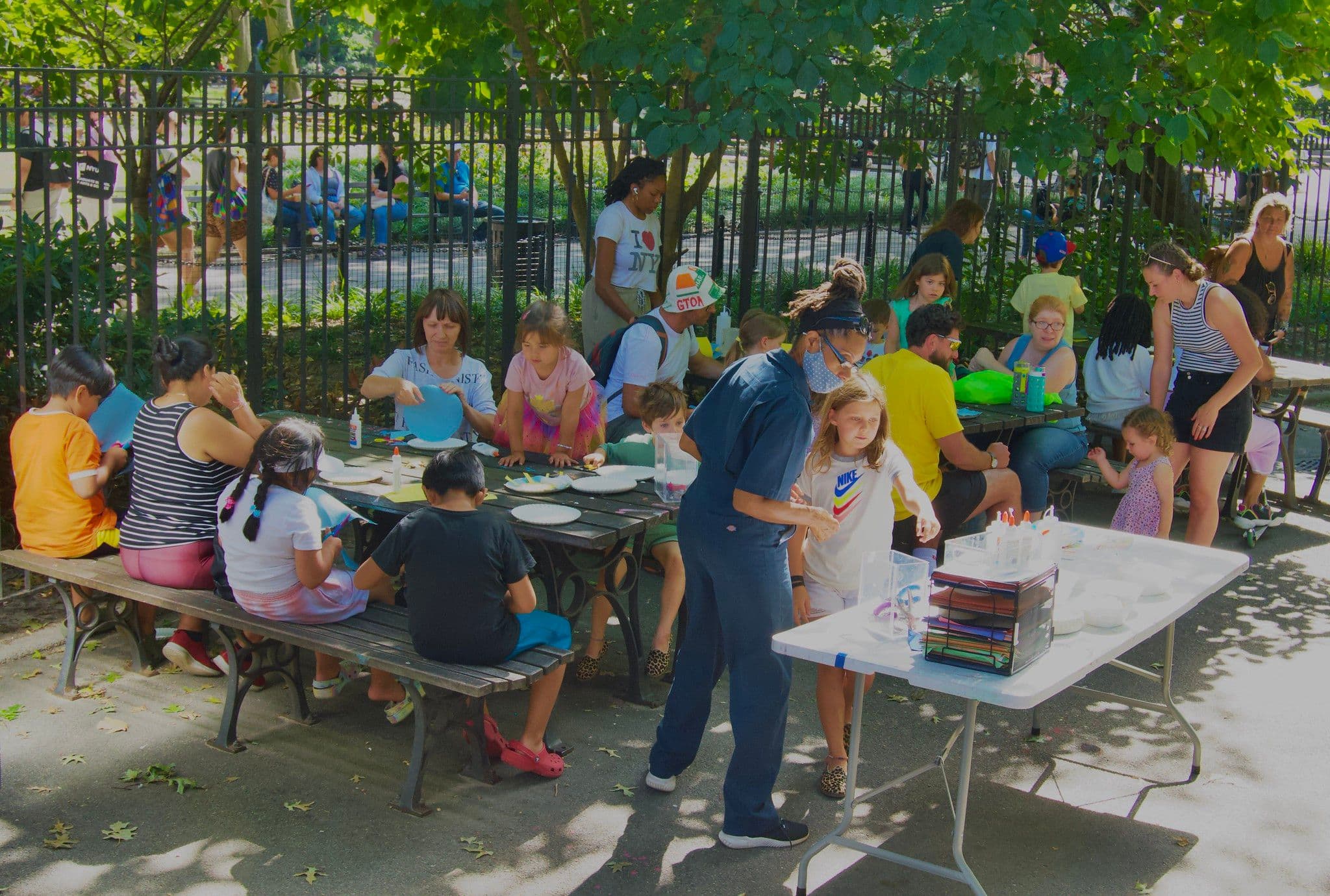 A large group of kids make art in the park.